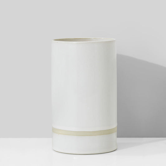 White cylindrical vase with a thin beige band on a light gray background