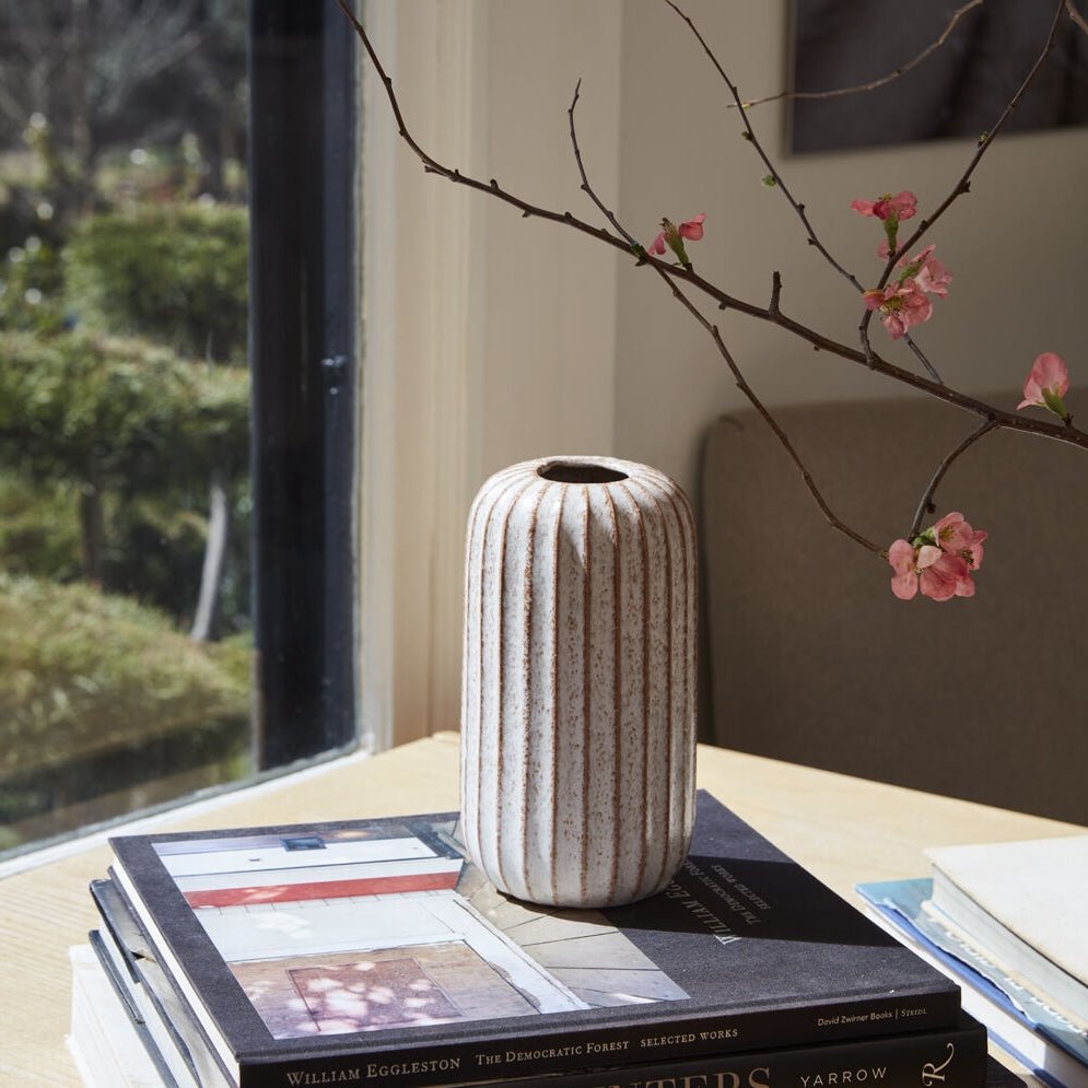 Tall Ginger Ceramic Bud Vase on a table with books