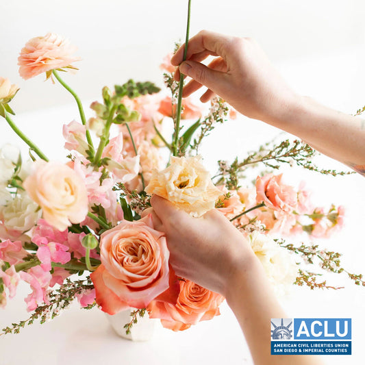 Person adding flowers to a flower arrangement - Aug. 2, 2025 - Flower Arranging 101 Workshop + ACLU Fundraiser