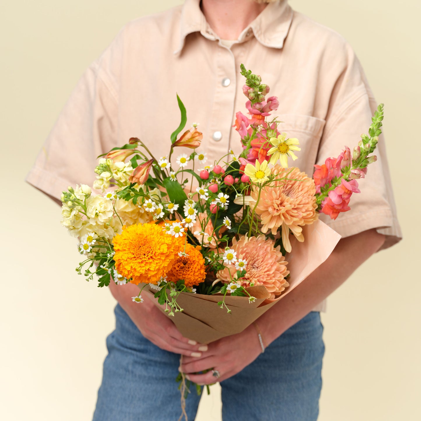 Woman holds classic bright + cheery flower bouquet wrap from Native Poppy