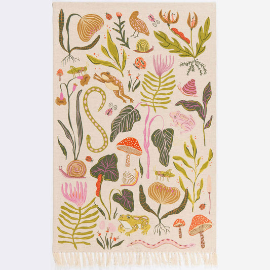 Decorative dishtowel with colorful floral and nature-themed pattern on a beige background