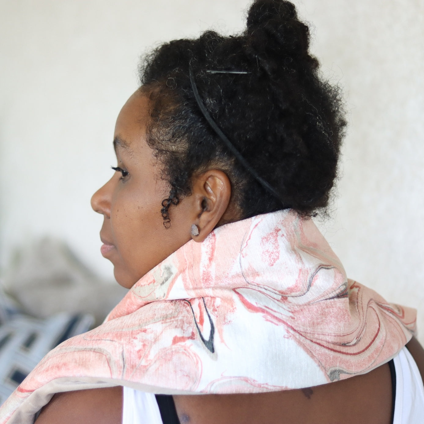 Woman wearing a Heatable Therapy Spa Wrap on her shoulders
