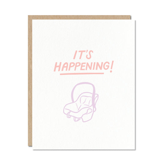 Greeting card with 'IT'S HAPPENING!' text and a baby car seat outline on a white background.