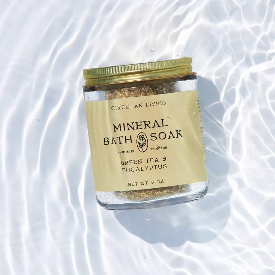 Jar of Mineral Bath Soak with a gold lid on a white background