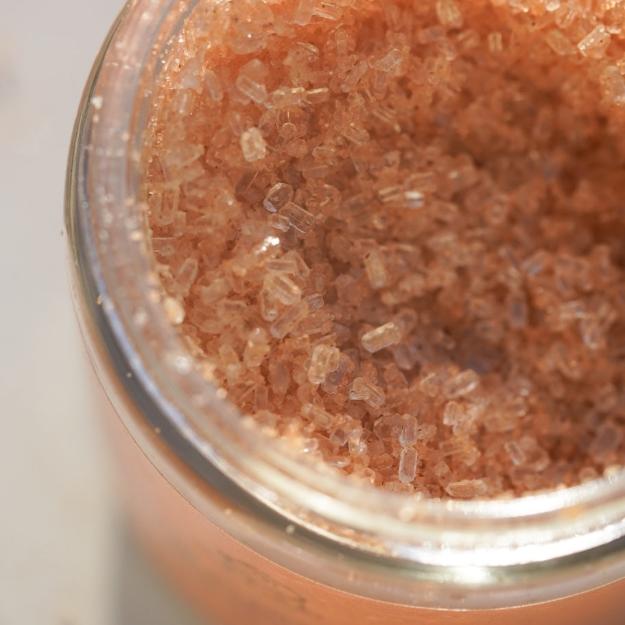 Close-up of a glass container filled with mineral bath soak