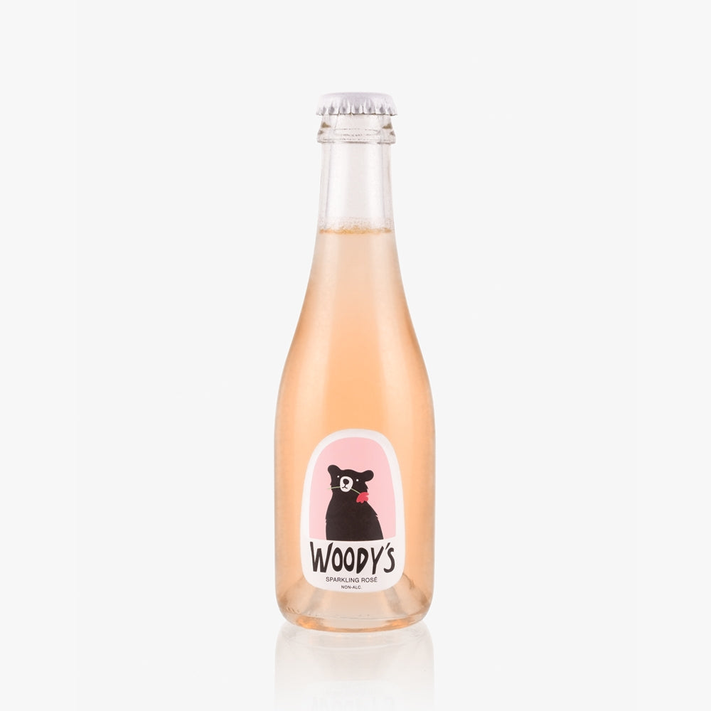 Mini bottle of Woody's sparkling rose on a white background