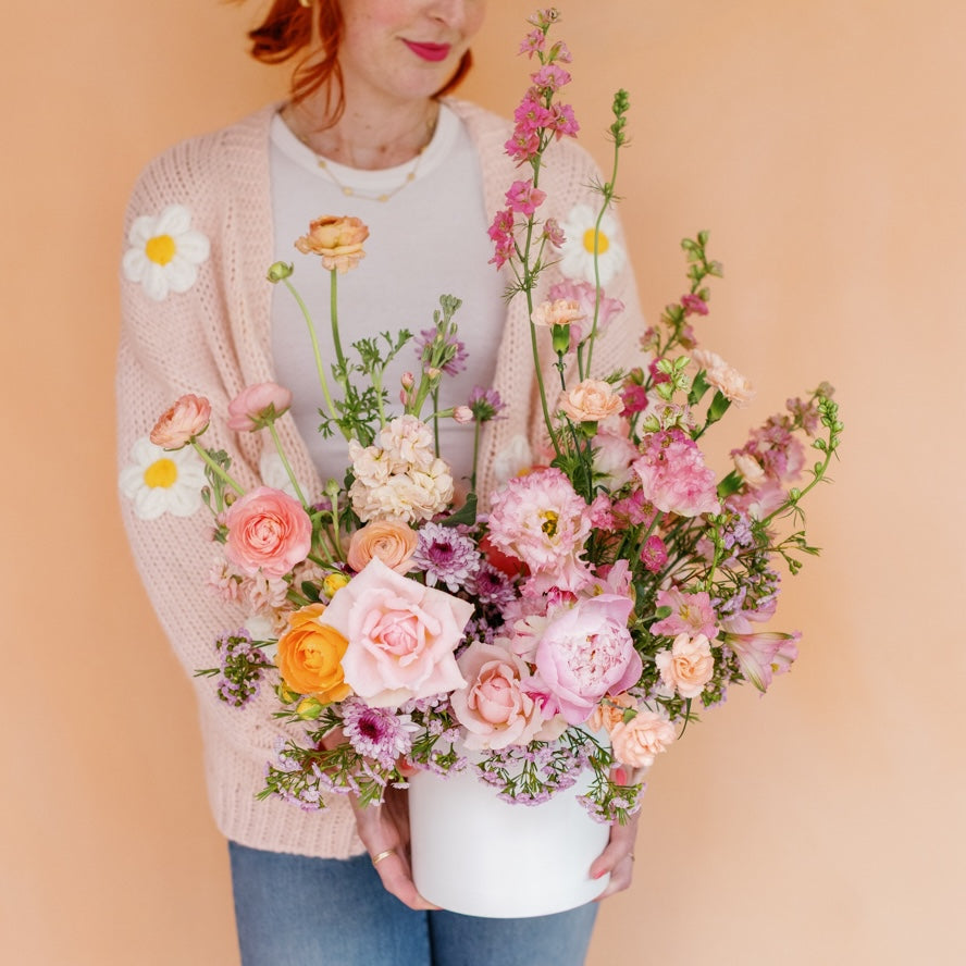 Meg Blancato holds a premium Mother's Day flower arrangement from Native Poppy