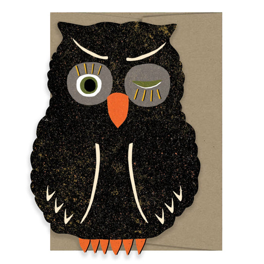 Card with a black owl design on a beige background
