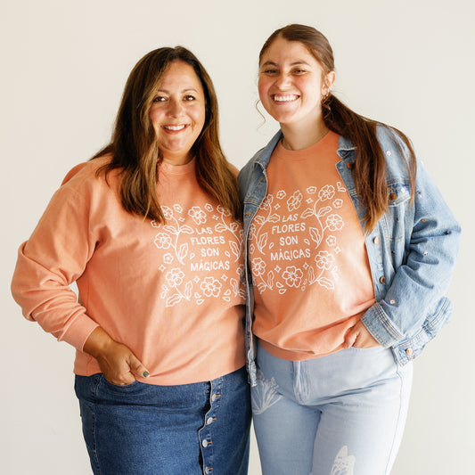 Cassie and Gaby wearing Las Flores Son Mágicas Sweatshirts