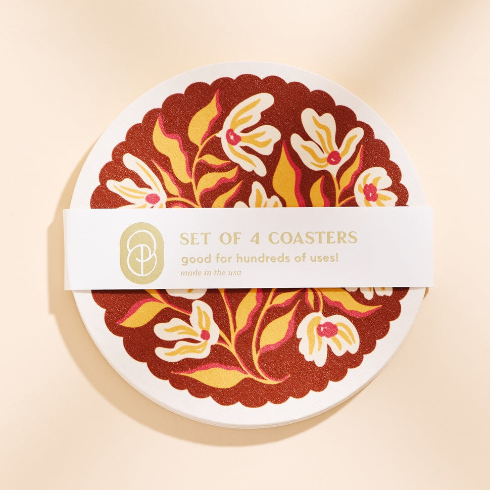 Set of 4 coasters with floral design on a beige background