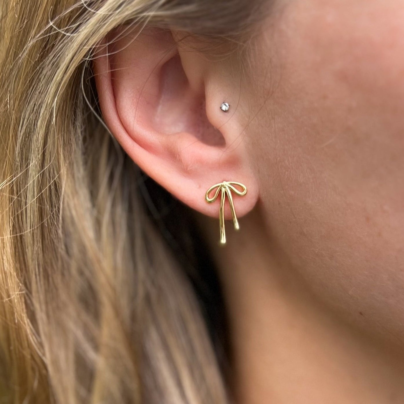 Woman wearing Golden Bow Stud Earring