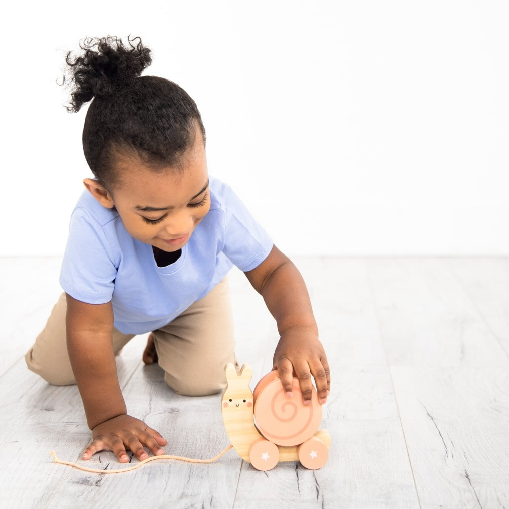 Child playing with Snail Wooden Pull Toy