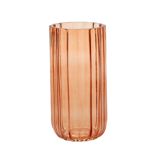 Cylindrical glass vase with a ribbed texture in peach color on a white background