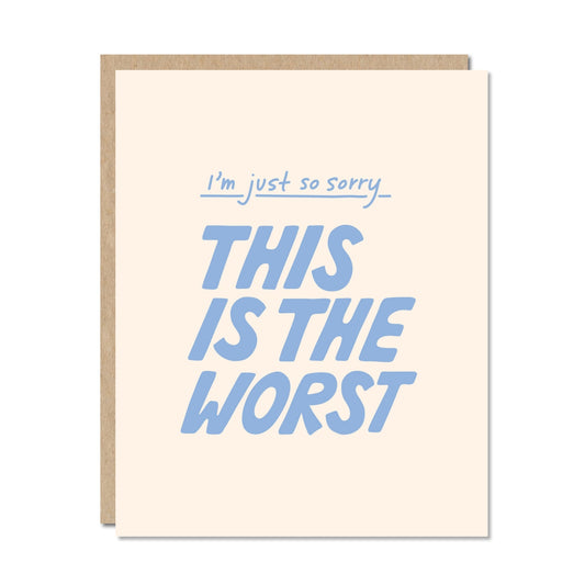 Card with blue text 'I'm just so sorry, this is the worst' on a beige background
