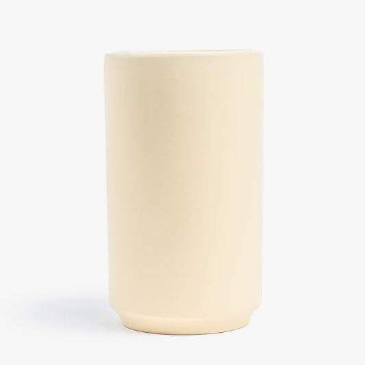 Beige ceramic tumbler on a white background