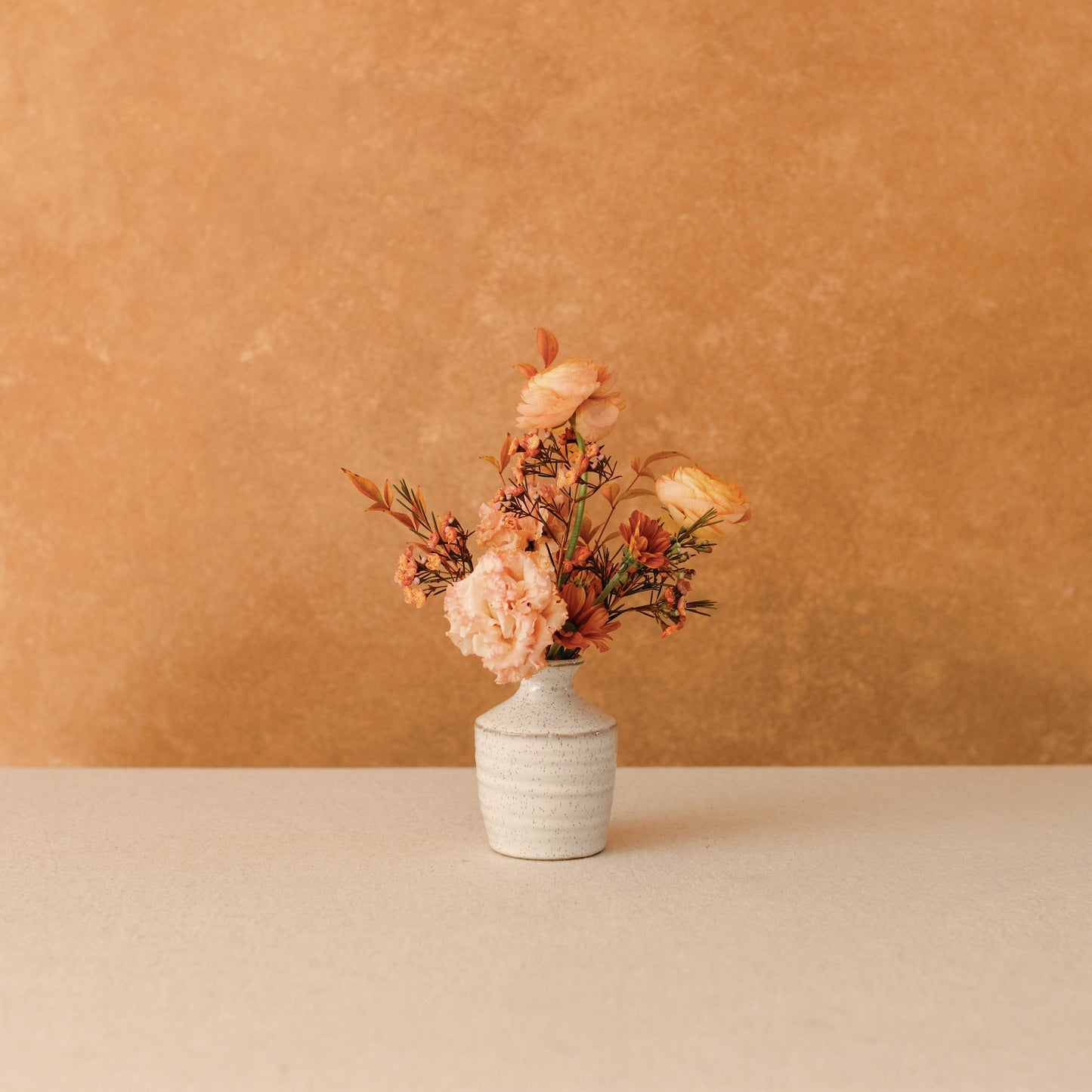 Fall flowers in a medium sized ceramic bud vase