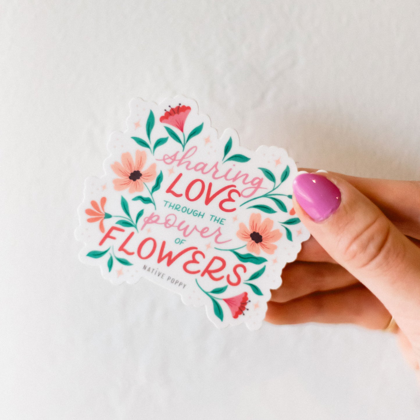 power of flowers sticker held by hand