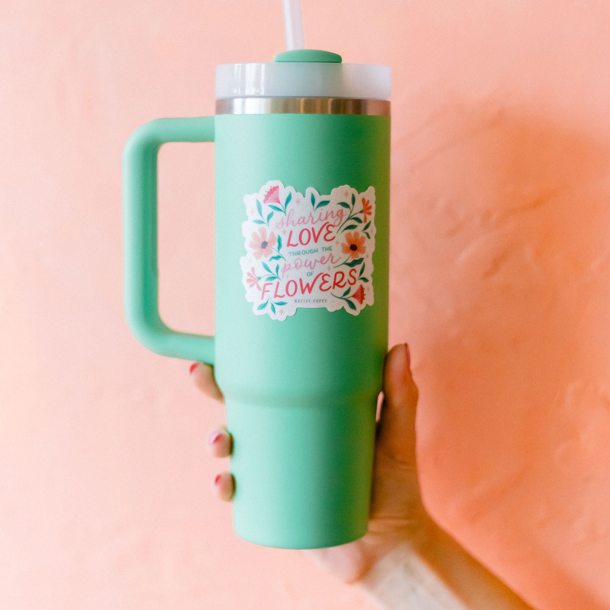 power of flowers sticker on a green waterbottle
