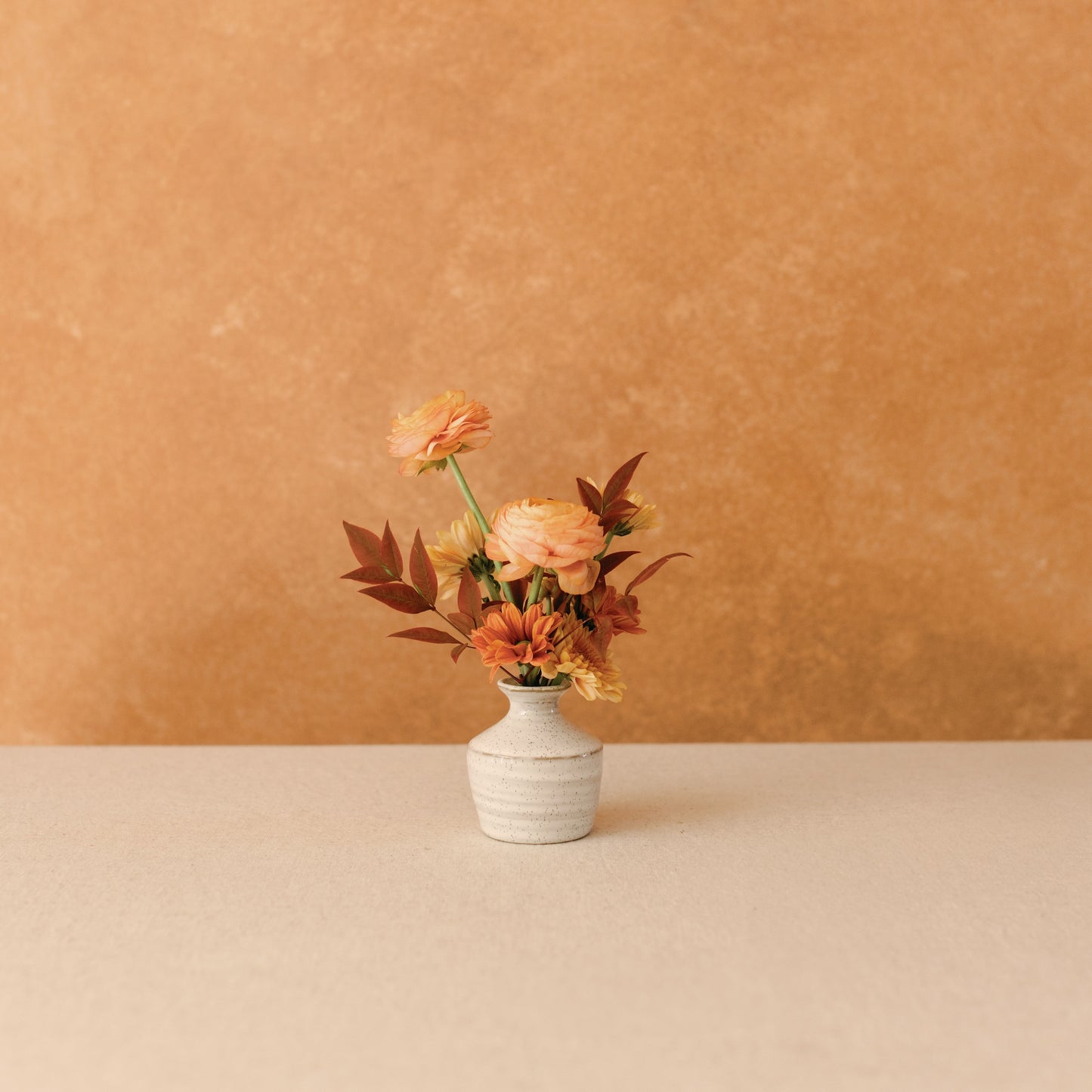 Fall flowers in a small size ceramic bud vase
