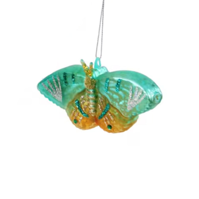 Decorative butterfly ornament with teal and orange colors on a white background
