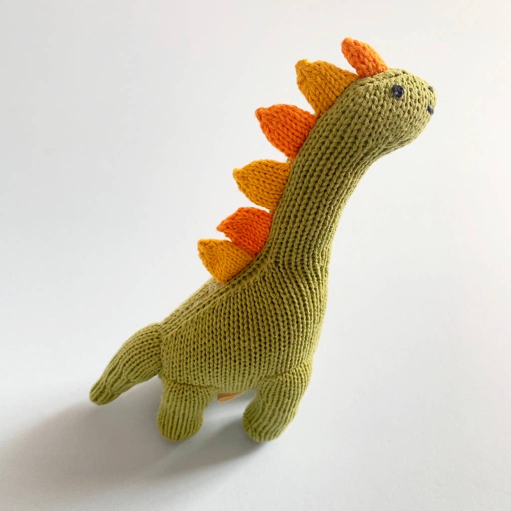 Profile view of light green dino knit softie