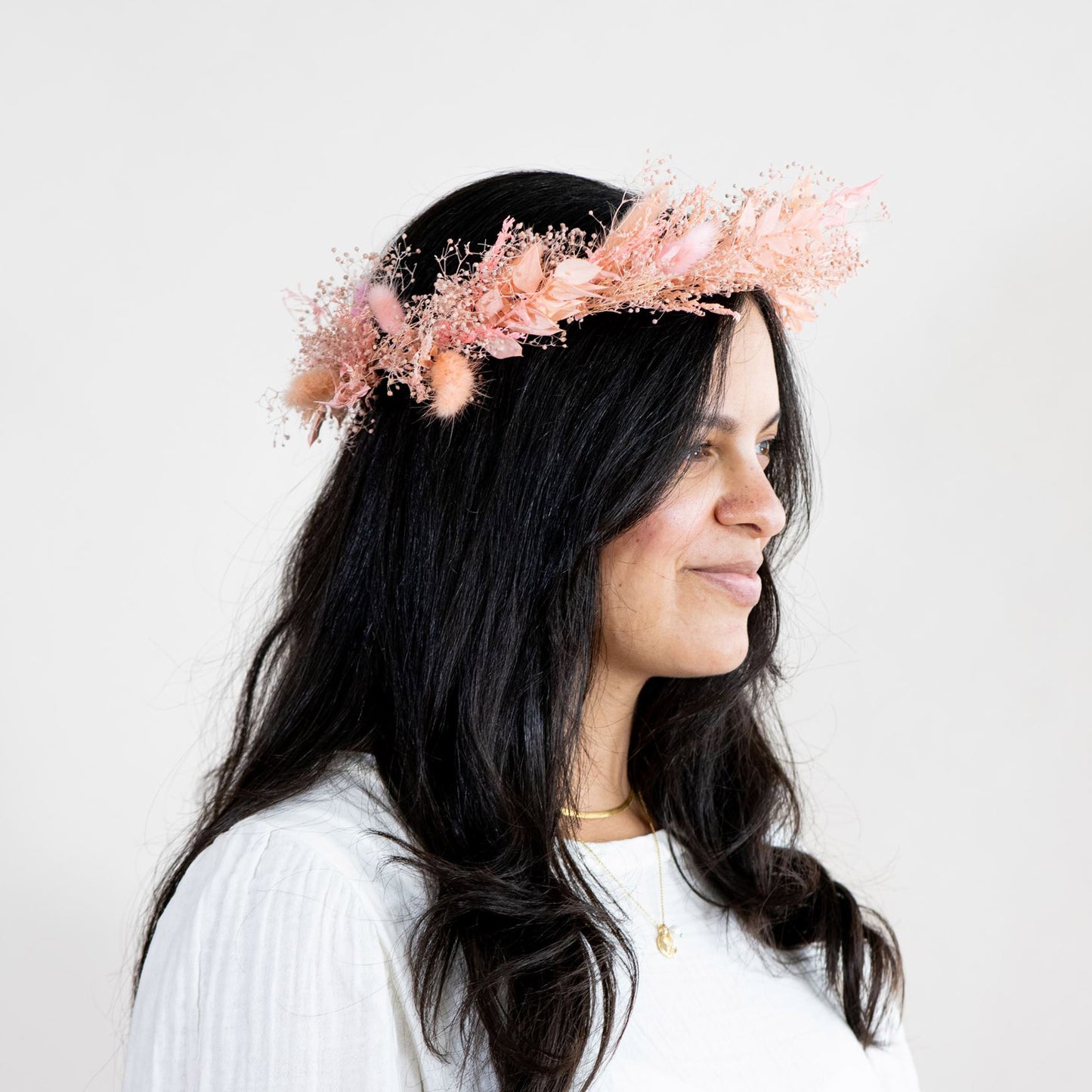 Side view of a model wearing peach dried flower crown from Native Poppy