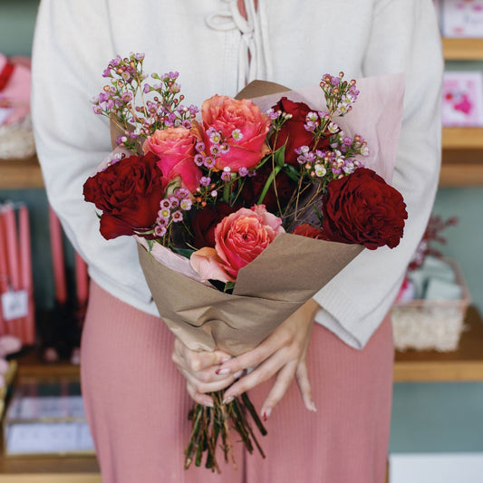 Woman holding rose bouquet from Native Poppy