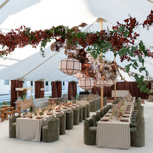 Dark red floral hanging install in a tent for a wedding