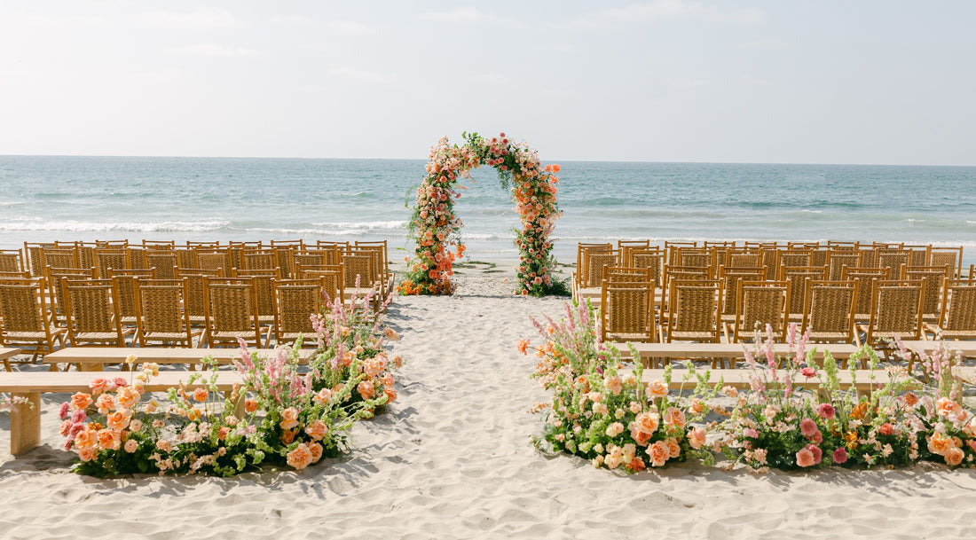 Wedding aisle with floral arch on the beach in La Jolla