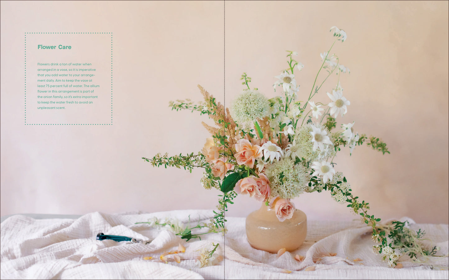 Floral arrangement in a vase on a white surface with a neutral background
