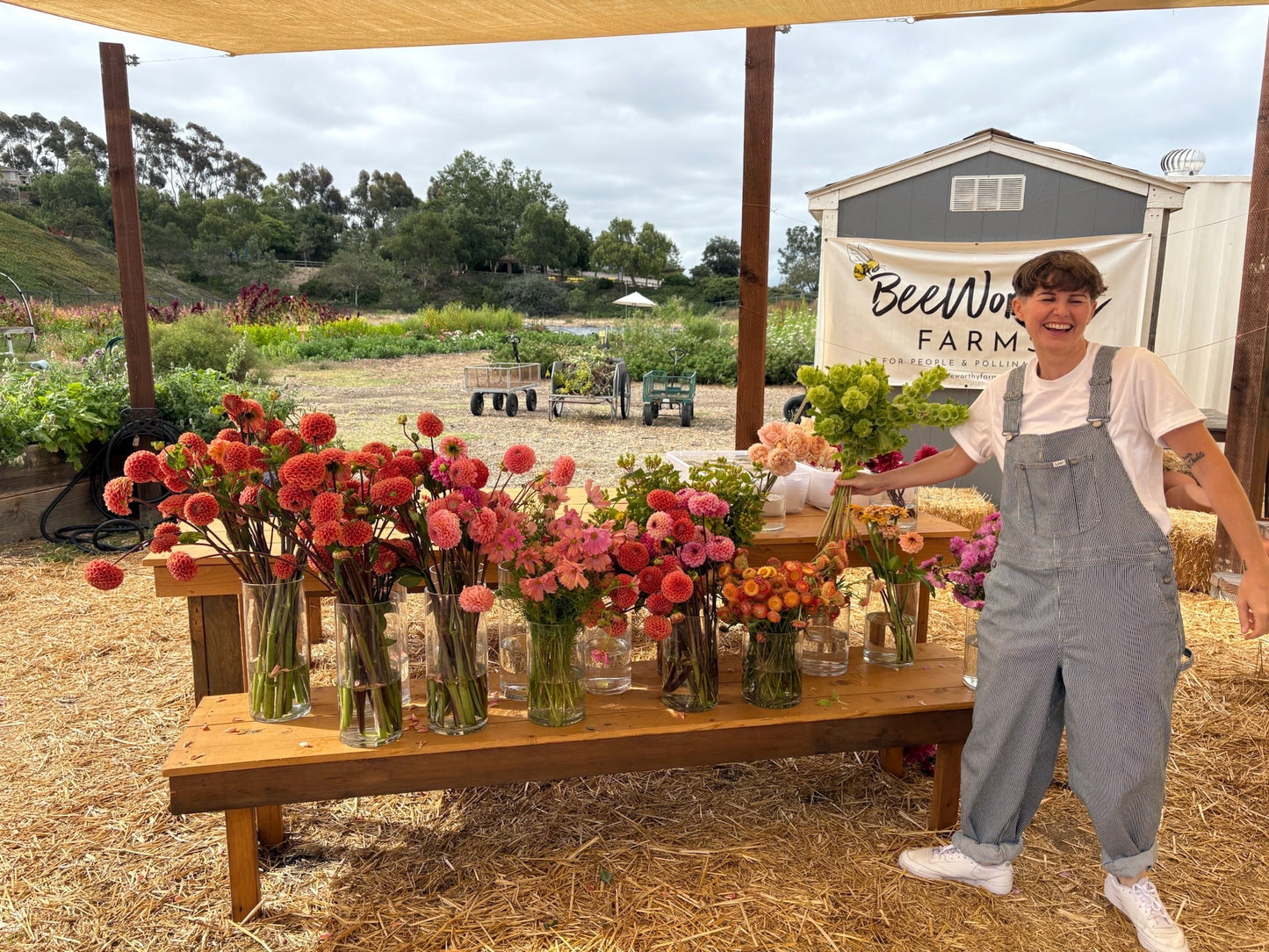 Jesse standing next to a table with flowers at BeeWorthy Farms