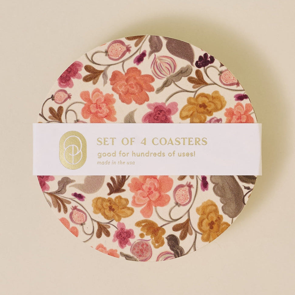 Set of 4 floral coasters in packaging with a visible brand logo.