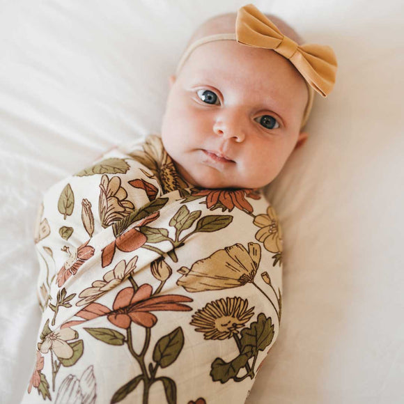 Bamboo Muslin Swaddle Blanket - Bohemian Blooms - wrapped around infant wearing bow