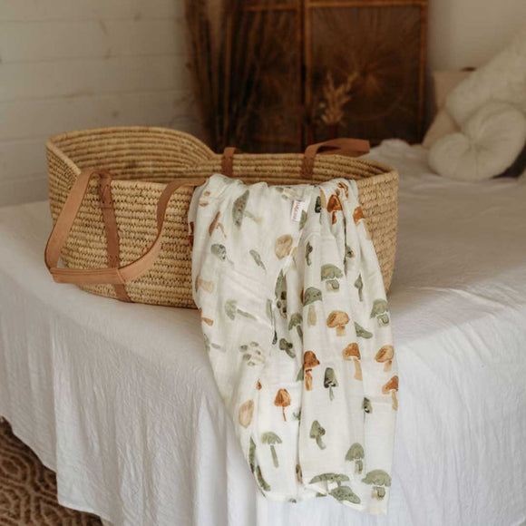 Bamboo Muslin Swaddle Blanket - Mushroom pattern - draped over basinette