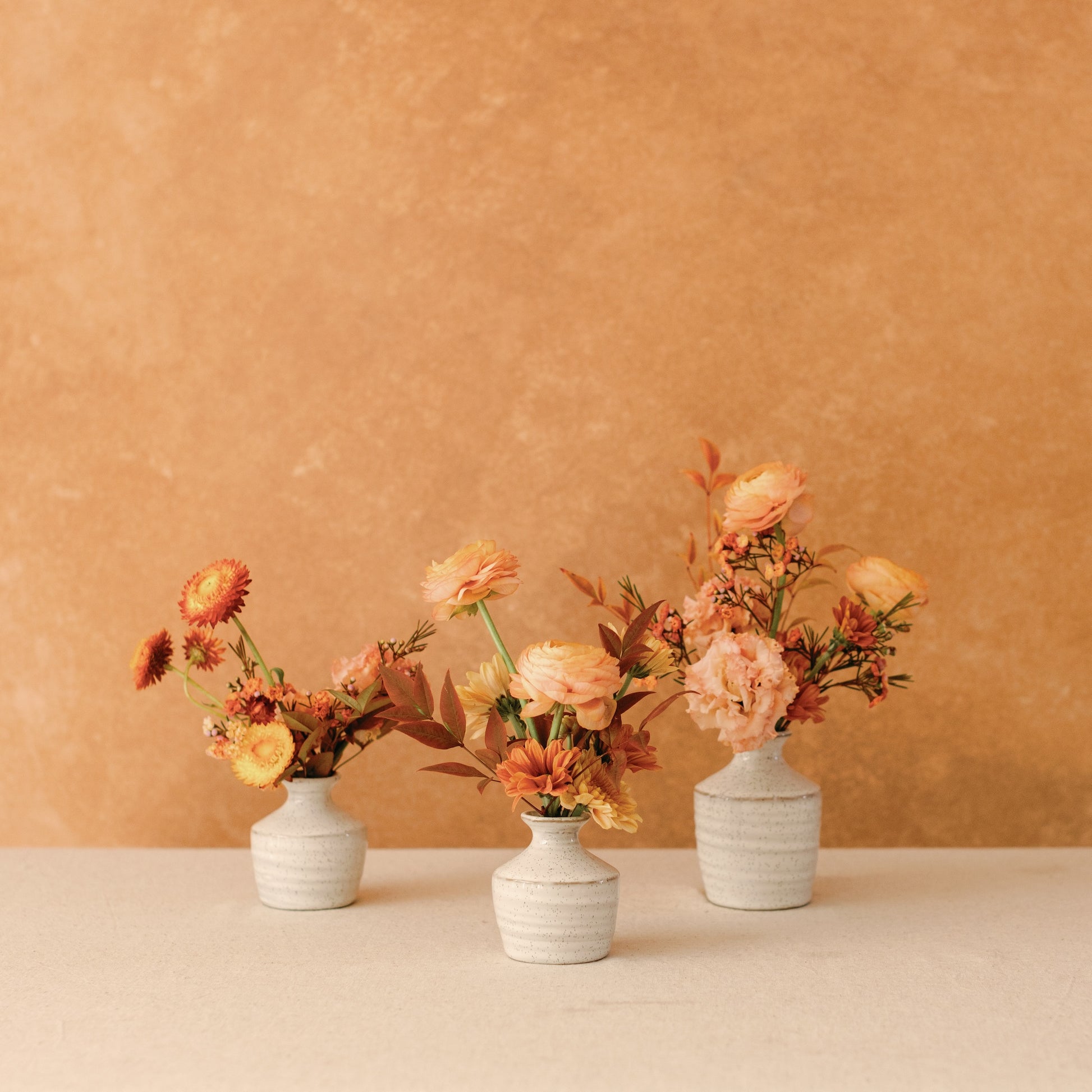 Thanksgiving flowers arranged in ceramic bud vases from Native Poppy