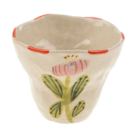 Add a playful touch to your dinnerware collection with the Flora Pottery Cup. Made from hand-formed stoneware and hand painted with a vibrant floral motif, each cup is a one-of-a-kind expression of traditional crafting methods. 