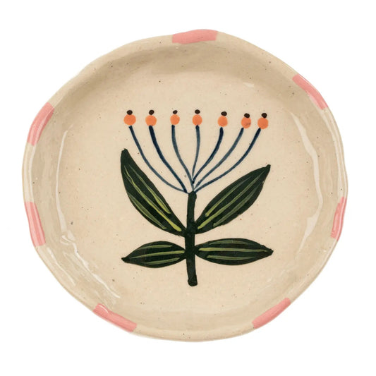 Add charm and function to your dinnerware collection with the Flora Pottery Mini Dish. Made from hand-formed stoneware and painted by hand with a vibrant floral design, each piece is a celebration of traditional crafting methods. 