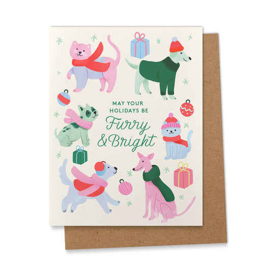 Greeting card with illustrations of dogs and cats wearing winter clothing and accessories, with a brown envelope.