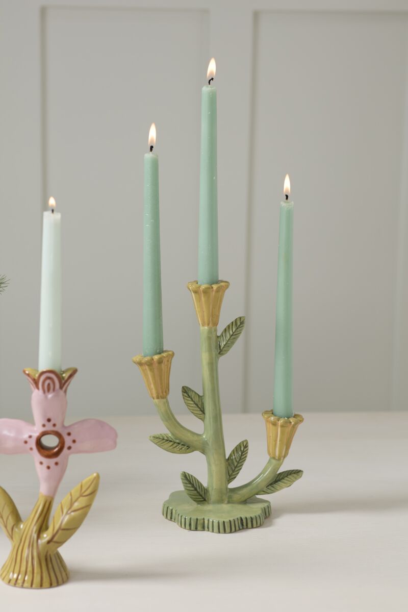 Decorative candle holders with candles on a plain background