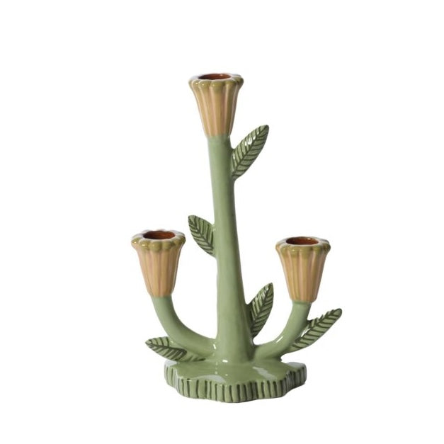 Green ceramic candle holder with leaf design on a white background
