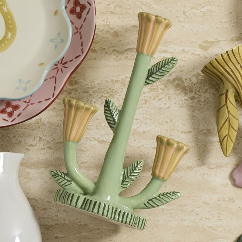 Decorative ceramic plant with gold accents on a textured surface