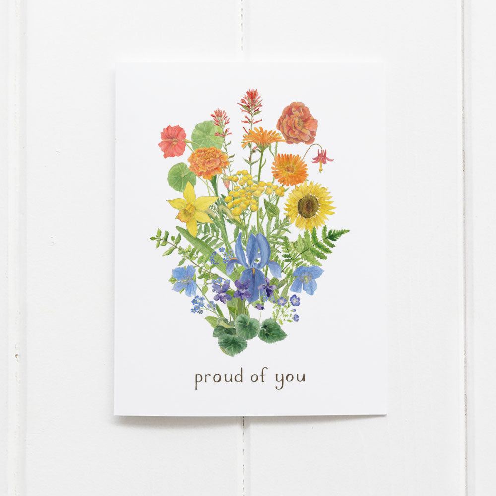 Greeting card with colorful floral design and 'proud of you' text on a white background