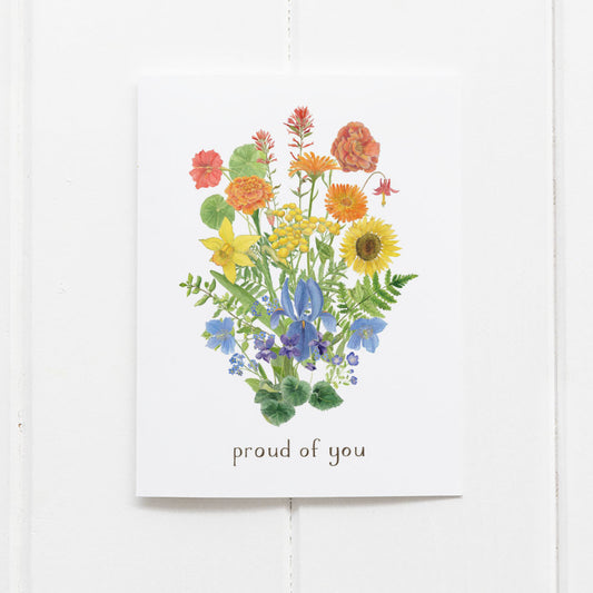 Greeting card with colorful floral design and 'proud of you' text on a white background
