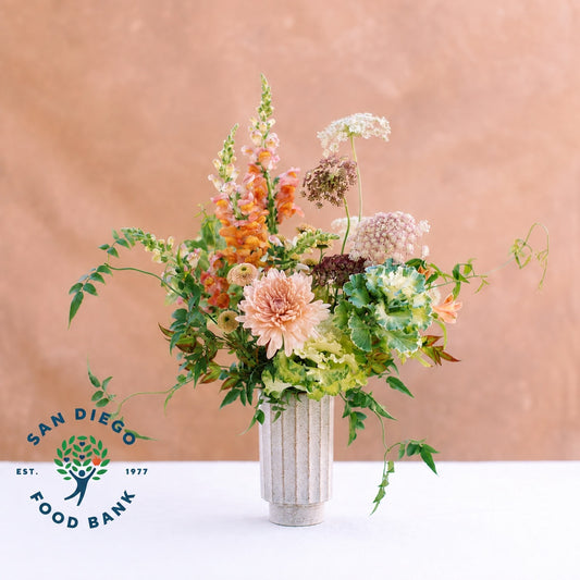 Celebrate autumn with beautiful blooms that evoke the harvest, artfully arranged in a modern sage green ceramic vase.

Every purchase of this flower arrangement helps support San Diego Food Bank, the largest hunger-relief organization in San Diego County, providing nutritious food to individuals and families in need. 15% of the proceeds from every Harvest Over Hunger Arrangement will be donated to the San Diego Food Bank.