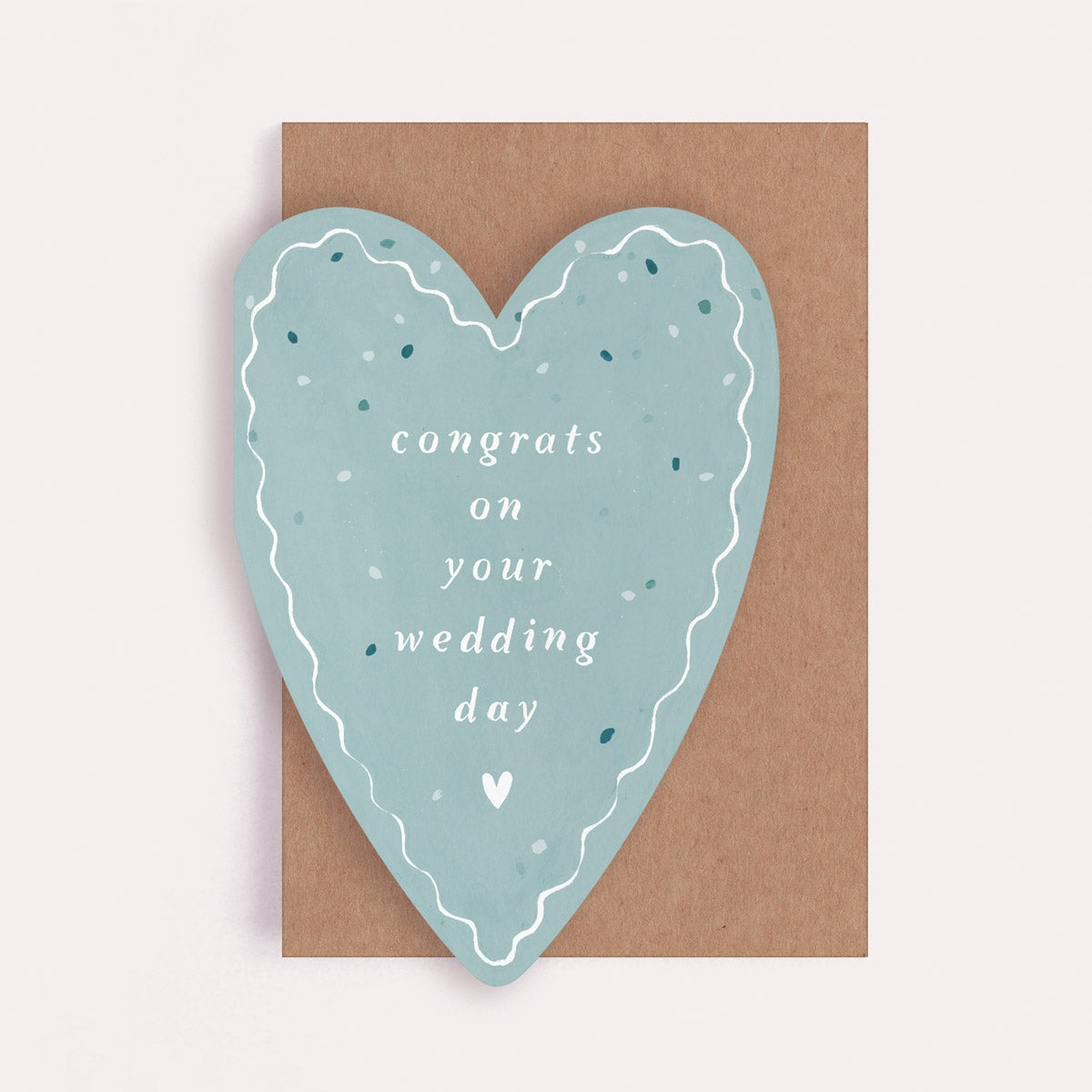 Heart-shaped card with 'congrats on your wedding day' text on a brown envelope