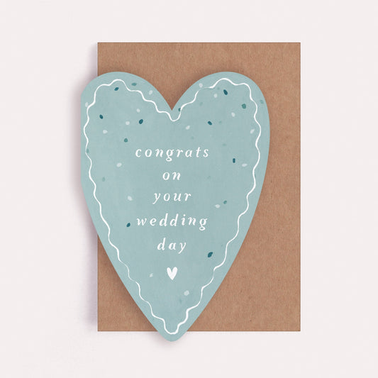 Heart-shaped card with 'congrats on your wedding day' text on a brown envelope