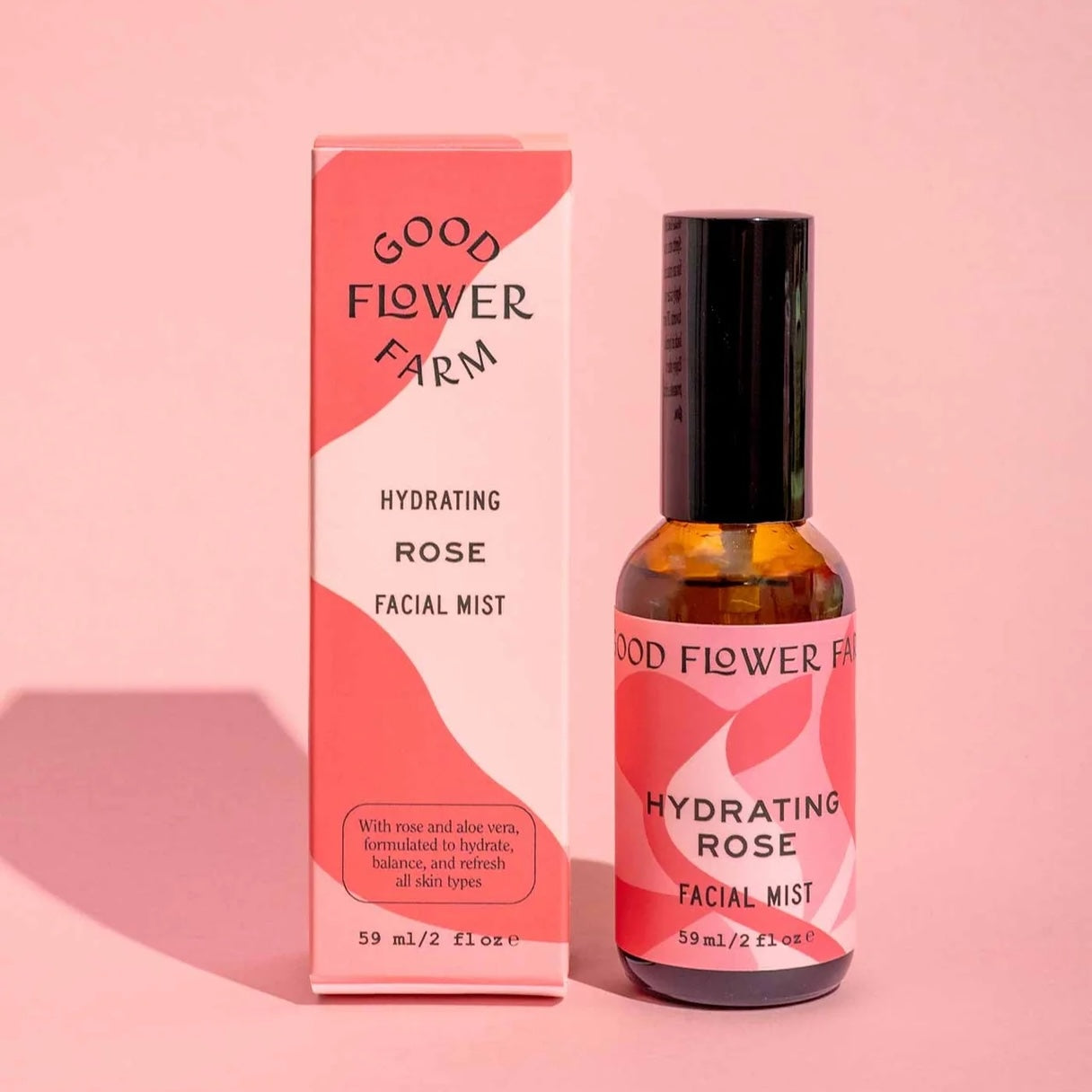 Good Flower Farm hydrating rose facial mist bottle and packaging on a pink background