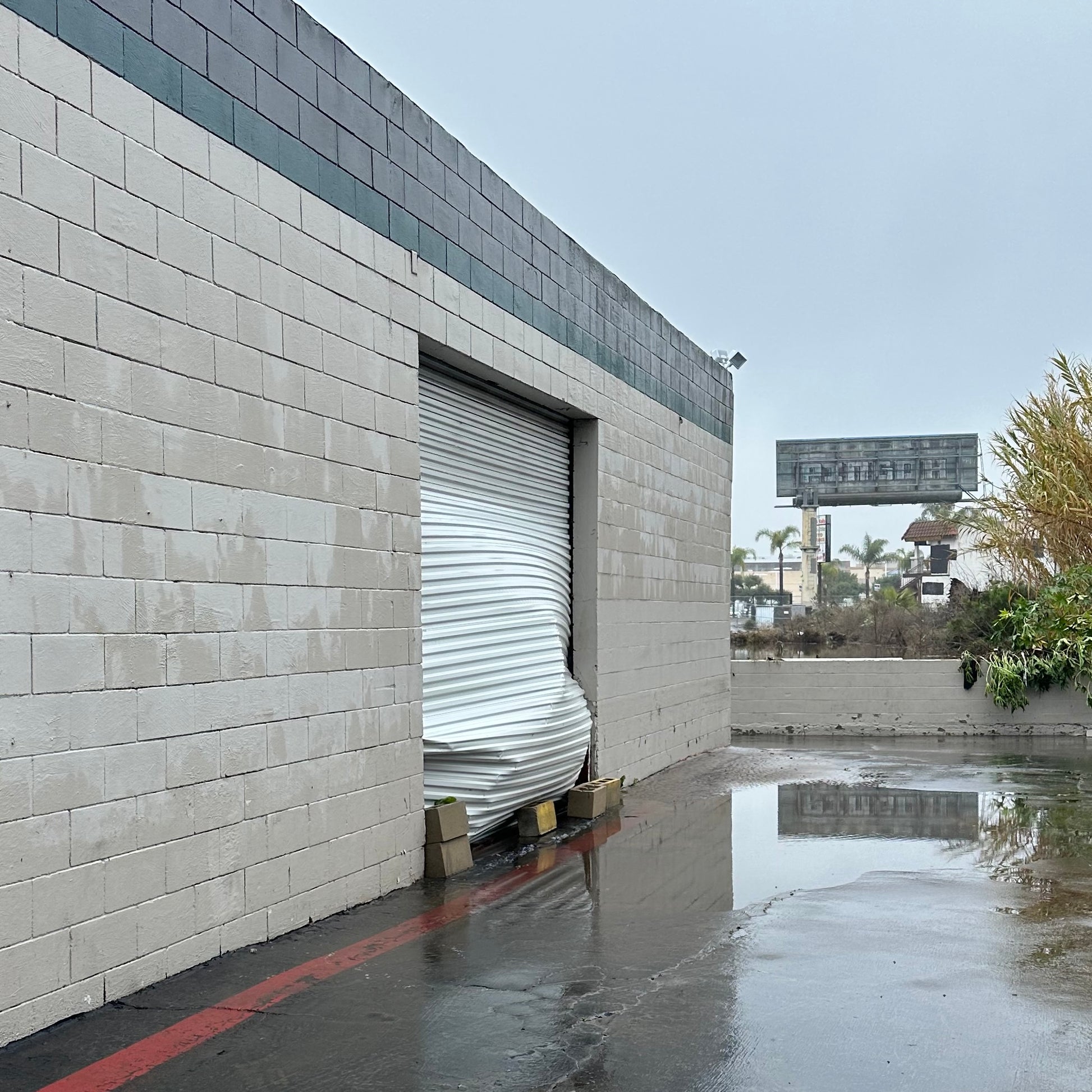 Flood damage to the door of Native Poppy's design warehouse in Mission Valley