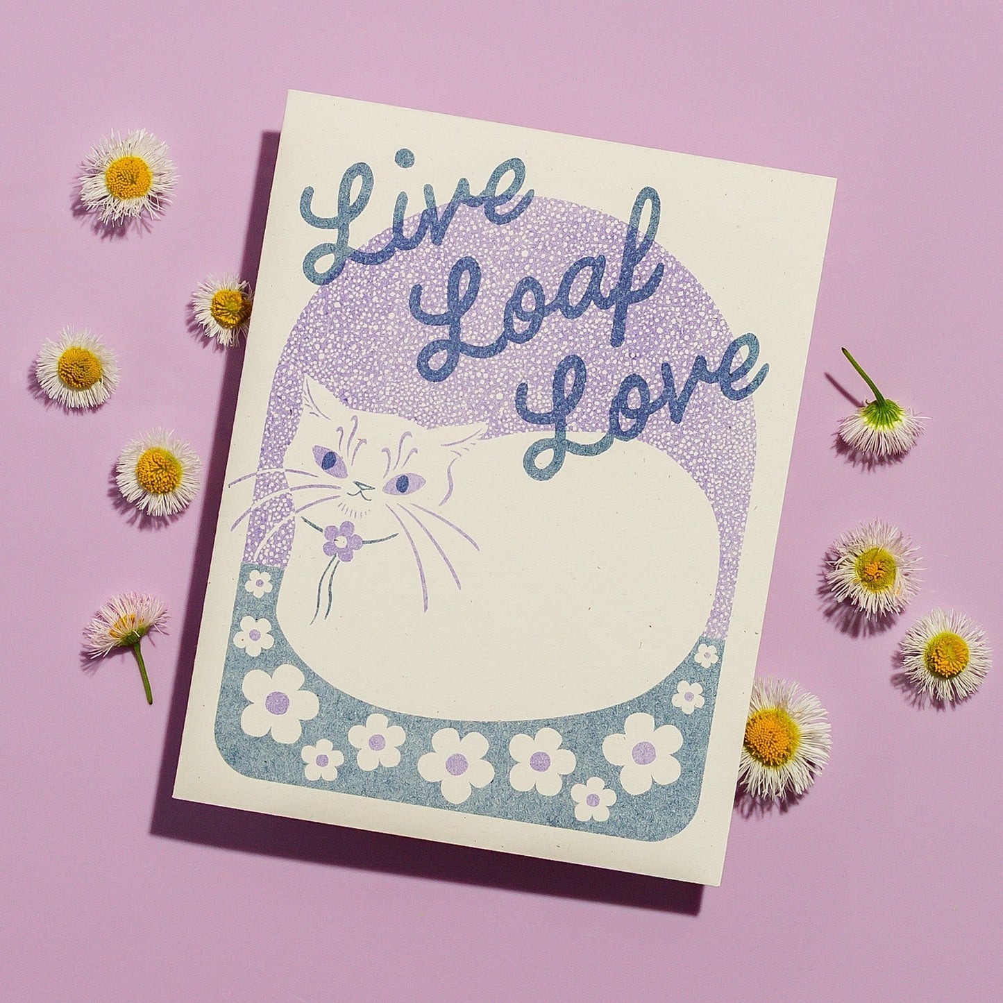 Card with a cat illustration and 'Live Loaf Love' text on a purple background with flowers.