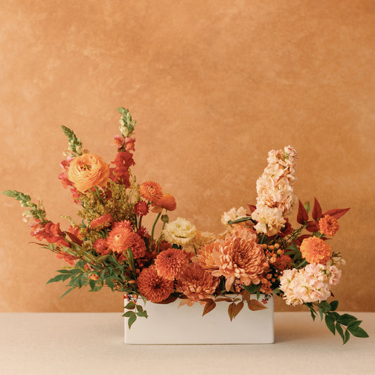 Thanksgiving Long & Low Arrangement with ivory, gold, peach, rust, and pink blooms